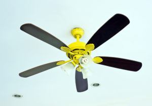 black fan with gold fixtures in a home